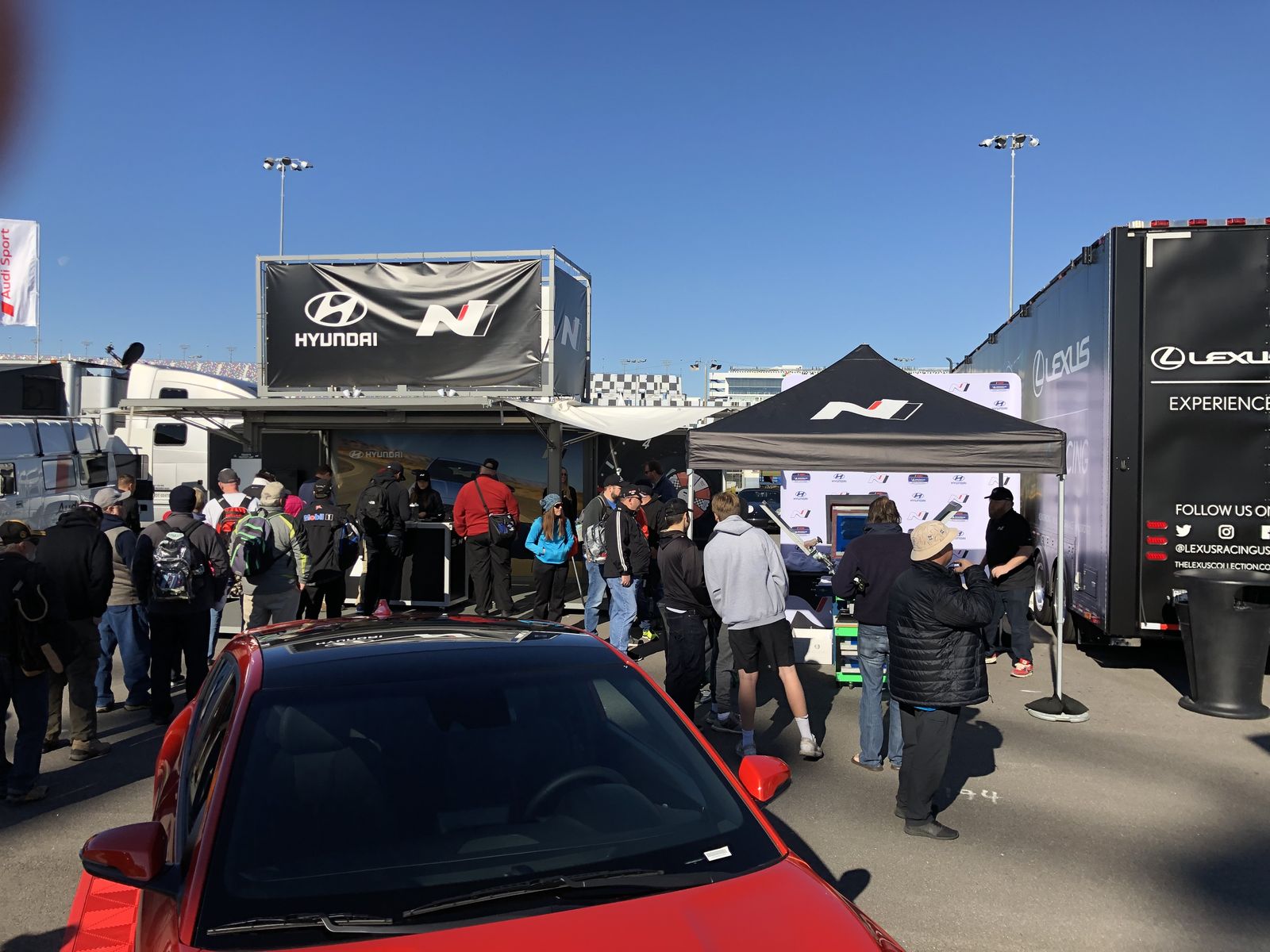 Outdoor sponsor activation with tents and trailers at a raceway